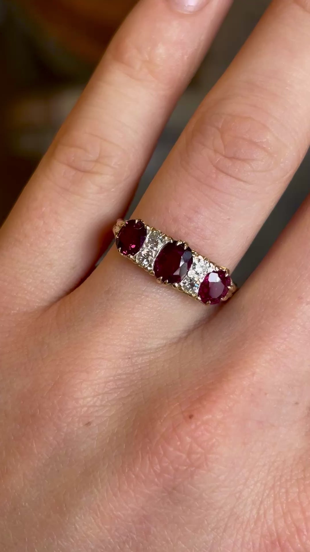 Antique, Victorian ruby and diamond three-stone ring worn on hand and moved backwards 