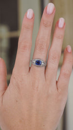 Video showing an antique Belle Époque sapphire ring on the hand, capturing the sparkle, scale and curved platinum design.