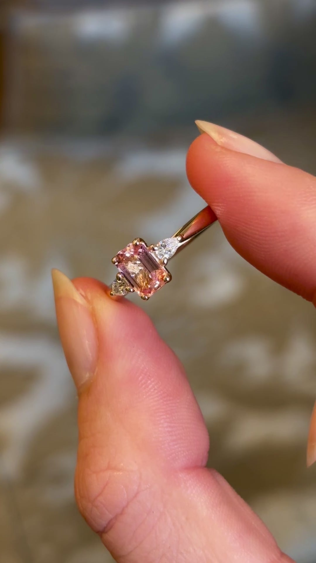 Pink sapphire and diamond three-stone engagement ring