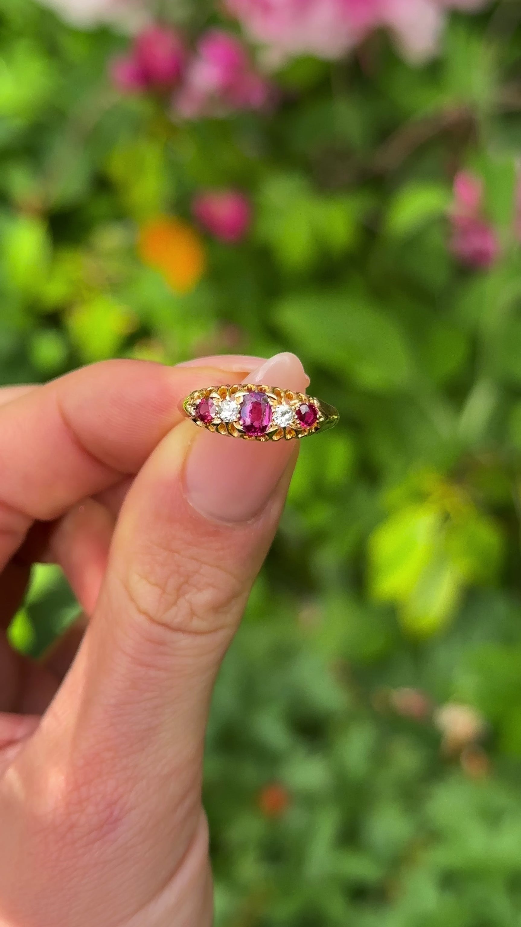 Antique, Edwardian Five Stone Ruby and Diamond Ring, 18ct Yellow Gold held in fingers.