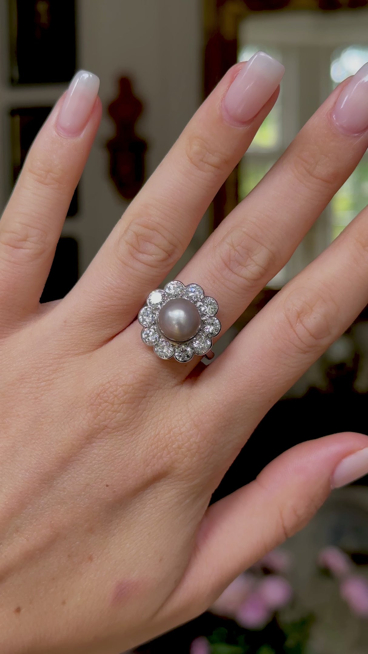 Antique natural pearl and diamond ring, worn on hand and rotated to give perspective. 