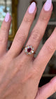 antique ruby and diamond cluster, worn on hand and moved away from lens to give perspective, front view.