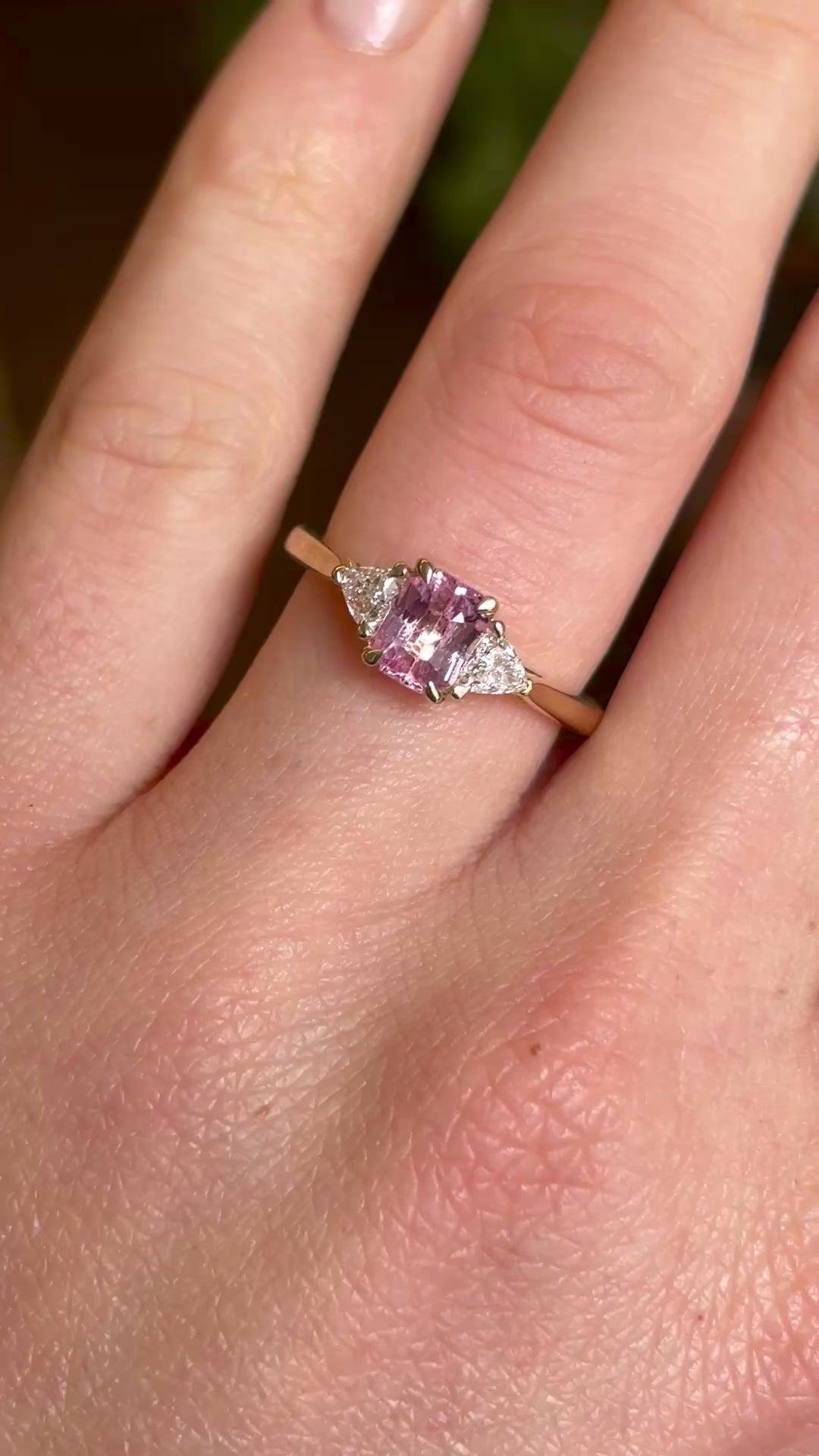 Pink sapphire and diamond three-stone engagement ring