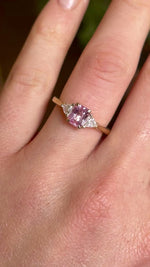 Pink sapphire and diamond three-stone engagement ring