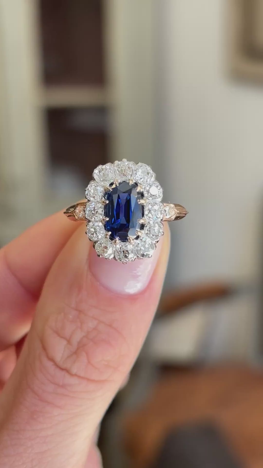 Close-up video of an antique Jugendstil royal-blue sapphire and diamond cluster ring, highlighting the rich royal-blue sapphire centre stone and surrounding diamonds in an elegant antique setting.