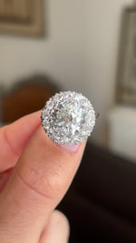 Close-up video of a vintage platinum diamond cluster ring, highlighting the brilliance of approximately 4 carats of diamonds, intricate cluster arrangement and timeless 1950s craftsmanship.