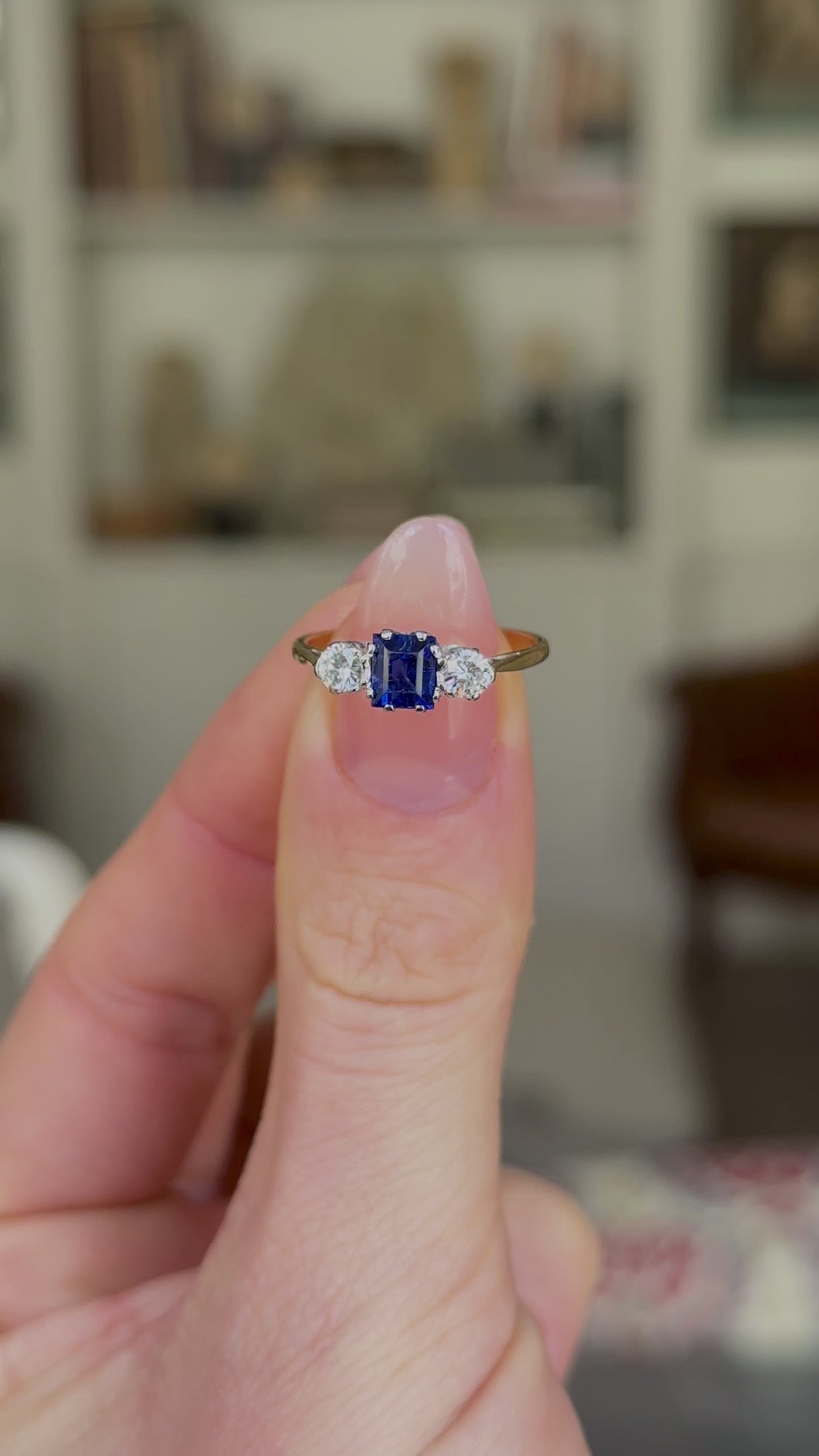 Antique, Edwardian Sapphire and Diamond Three-Stone Engagement Ring, 18ct Yellow Gold and Platinum held in fingers and rotated to give perspective.