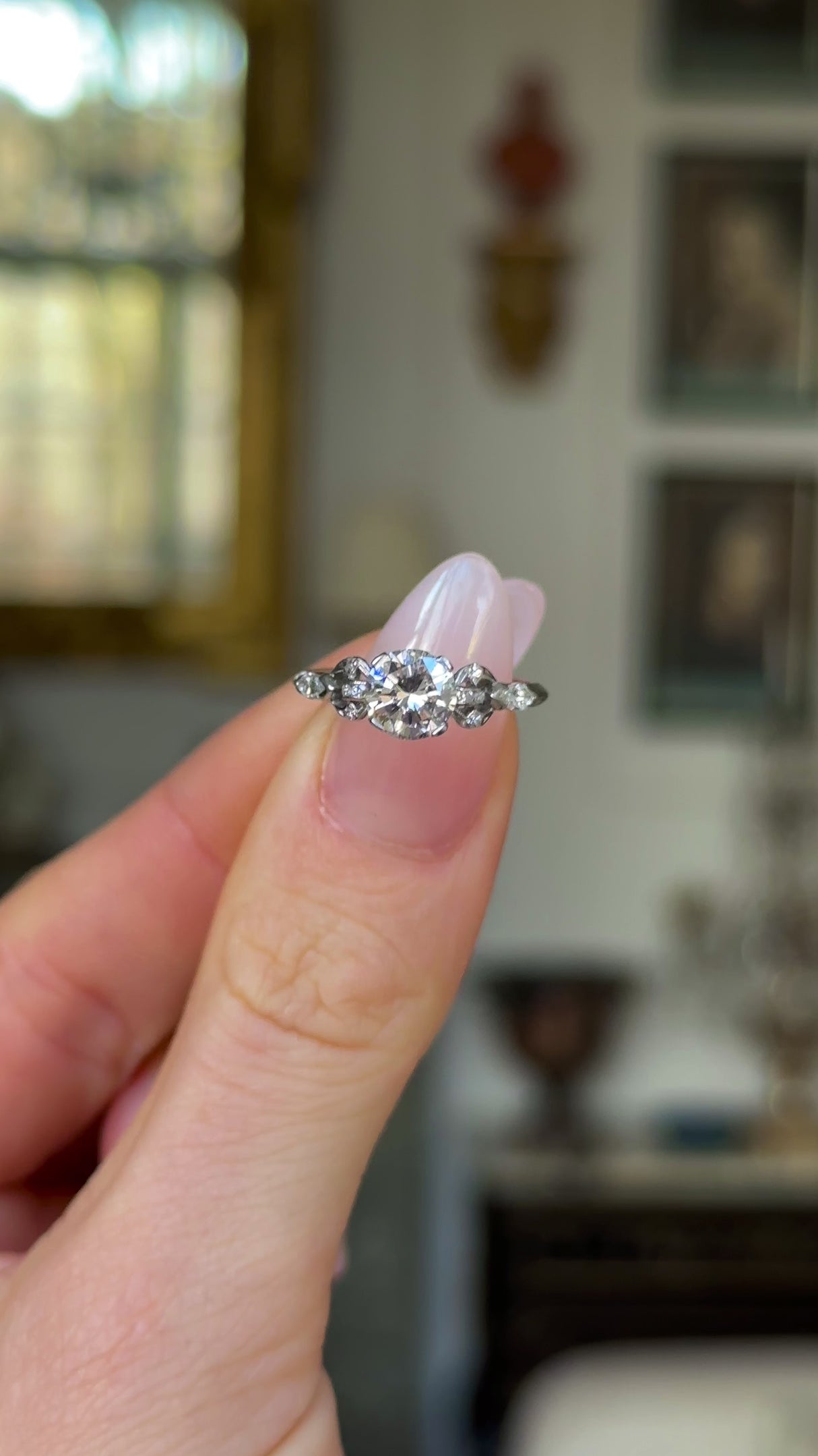 Vintage, 1950s Diamond Engagement Ring, 14ct White Gold and Platinum held in fingers and rotated to give perspective.