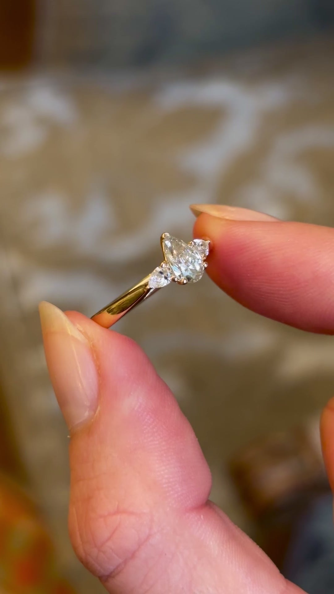 Pear-cut diamond three-stone engagement ring