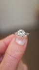 Vintage tinted yellow diamond ring showing light reflections and diamond set shoulders.