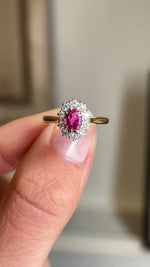 Close up video of a pink ruby and diamond cluster gold engagement ring, vintage from 1940.