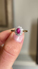Close up video of a pink ruby and diamond cluster gold engagement ring, vintage from 1940.