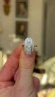 Vintage, Art Deco Three-Stone Diamond Panel Ring, Platinum held in fingers and rotated to give perspective.