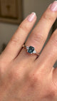 video of a Vintage-inspired, Teal sapphire and diamond three-stone engagement ring in platinum on a hand