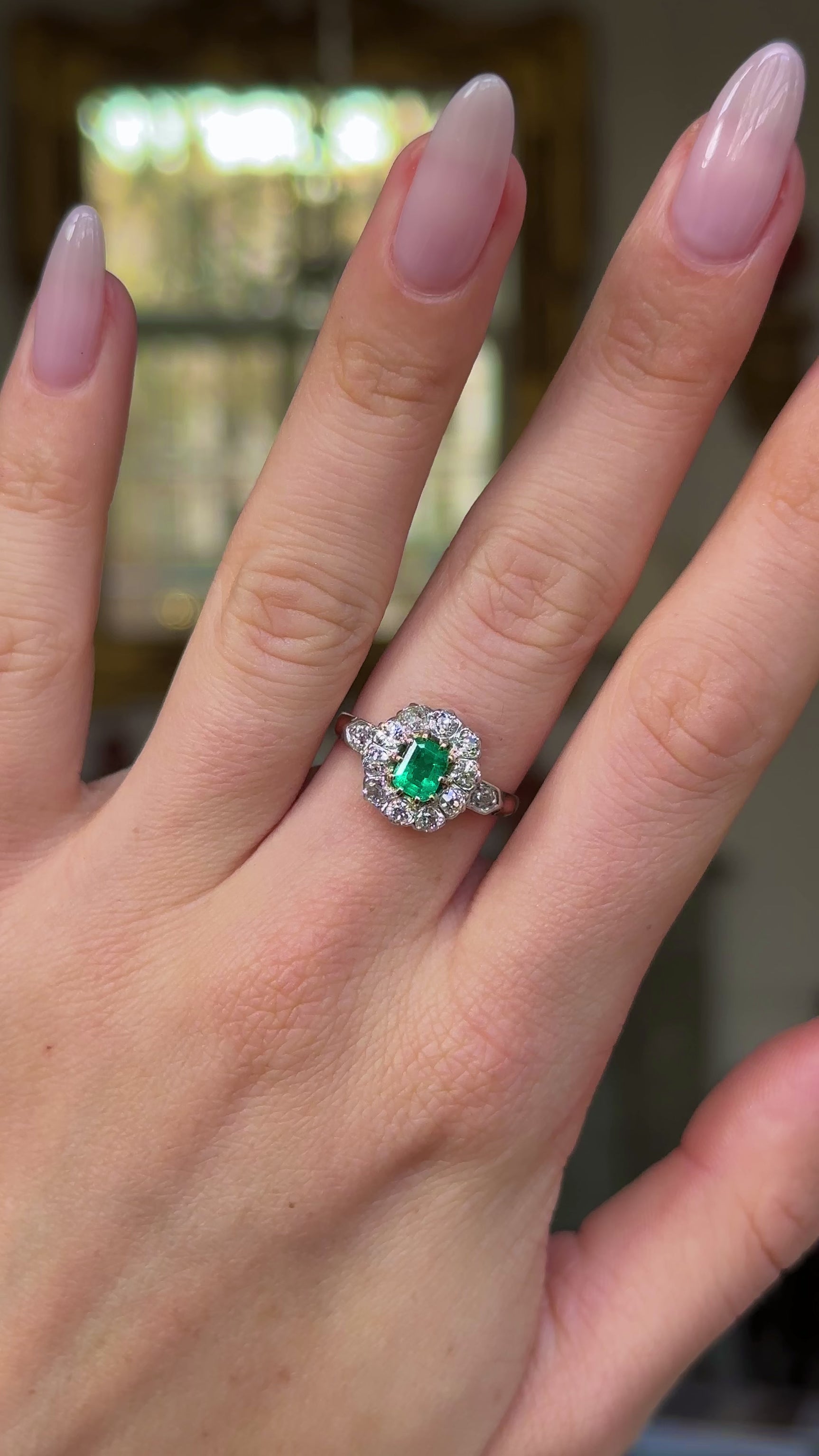 Edwardian emerald and diamond ring worn on hand and moved around to give perspective.
