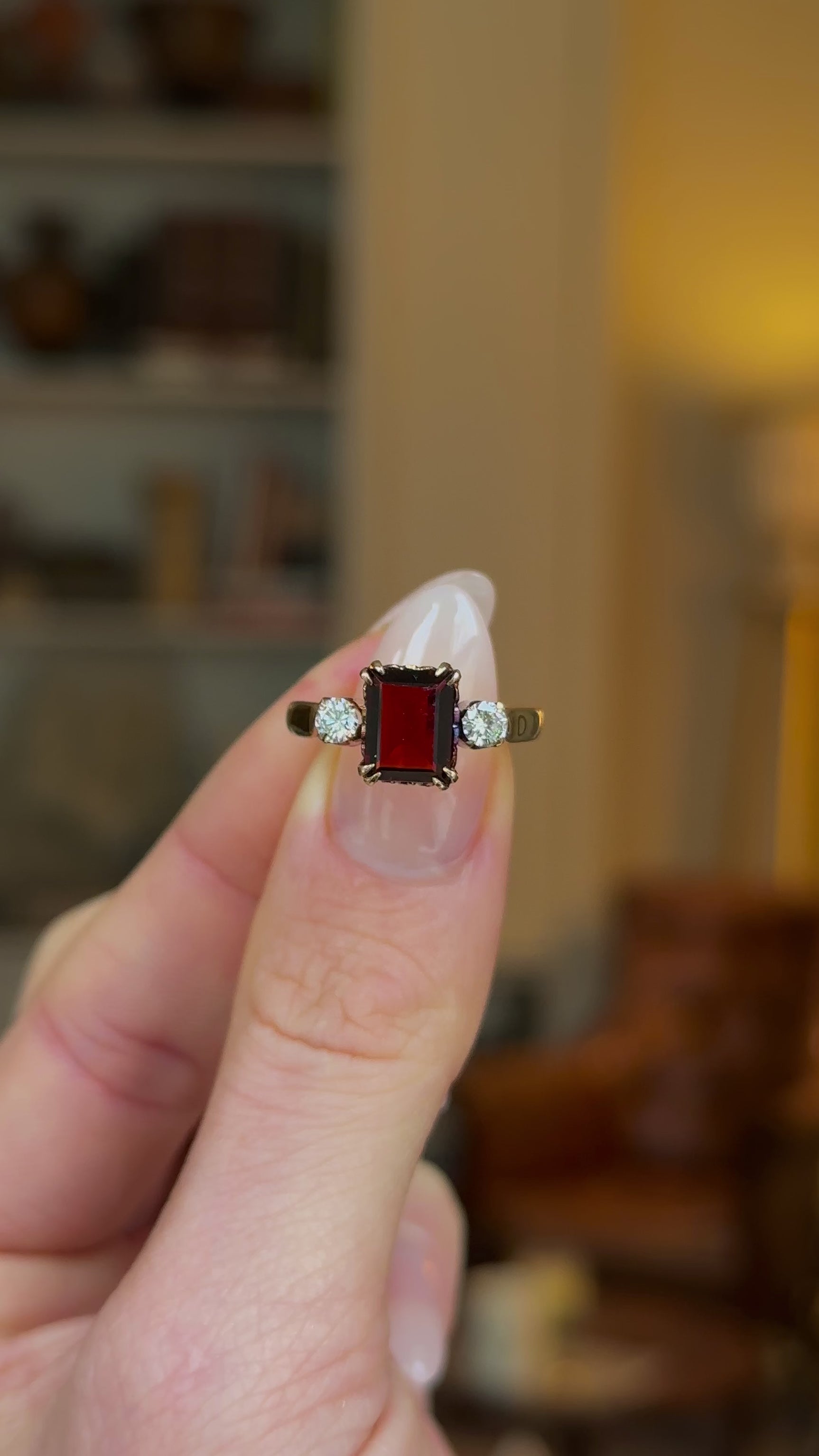 Vintage, 1940s Three-Stone Garnet and Diamond Ring, 18ct Rosy Yellow Gold held in fingers and rotated to give perspective.