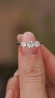 A video of an Antique, Edwardian diamond three-stone engagement ring in platinum held in between the fingers and slowly rotated to show different angles of the ring.