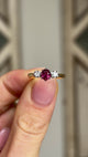 Antique, Edwardian ruby & diamond three-stone ring held in fingers