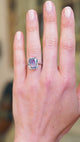 Solitaire ring worn on hand showing soft blue sapphire tone and natural movement.