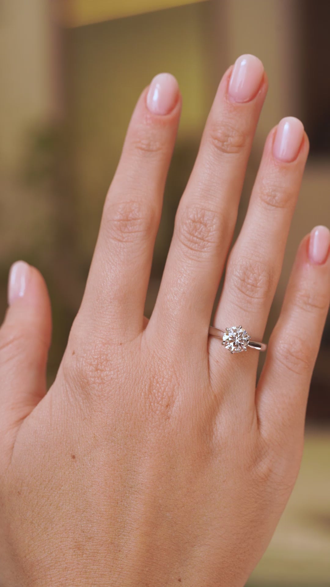 Video of a vintage lab-grown diamond solitaire engagement ring worn on the hand, showing its size and classic proportions.