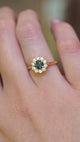 Antique-inspired, deep teal sapphire and diamond cluster engagement ring