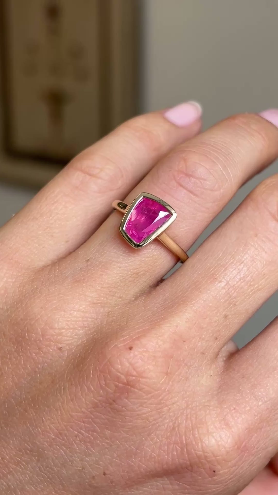 Video of a Vintage-inspired, pink ruby solitaire engagement ring in yellow gold on a hand