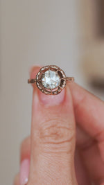Video close-up of a Victorian rose-cut diamond ring balanced on a fingertip, capturing its distinctive sparkle and antique construction.
