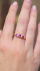 A video of an Edwardian ruby and diamond five-stone engagement ring displayed on the hand.