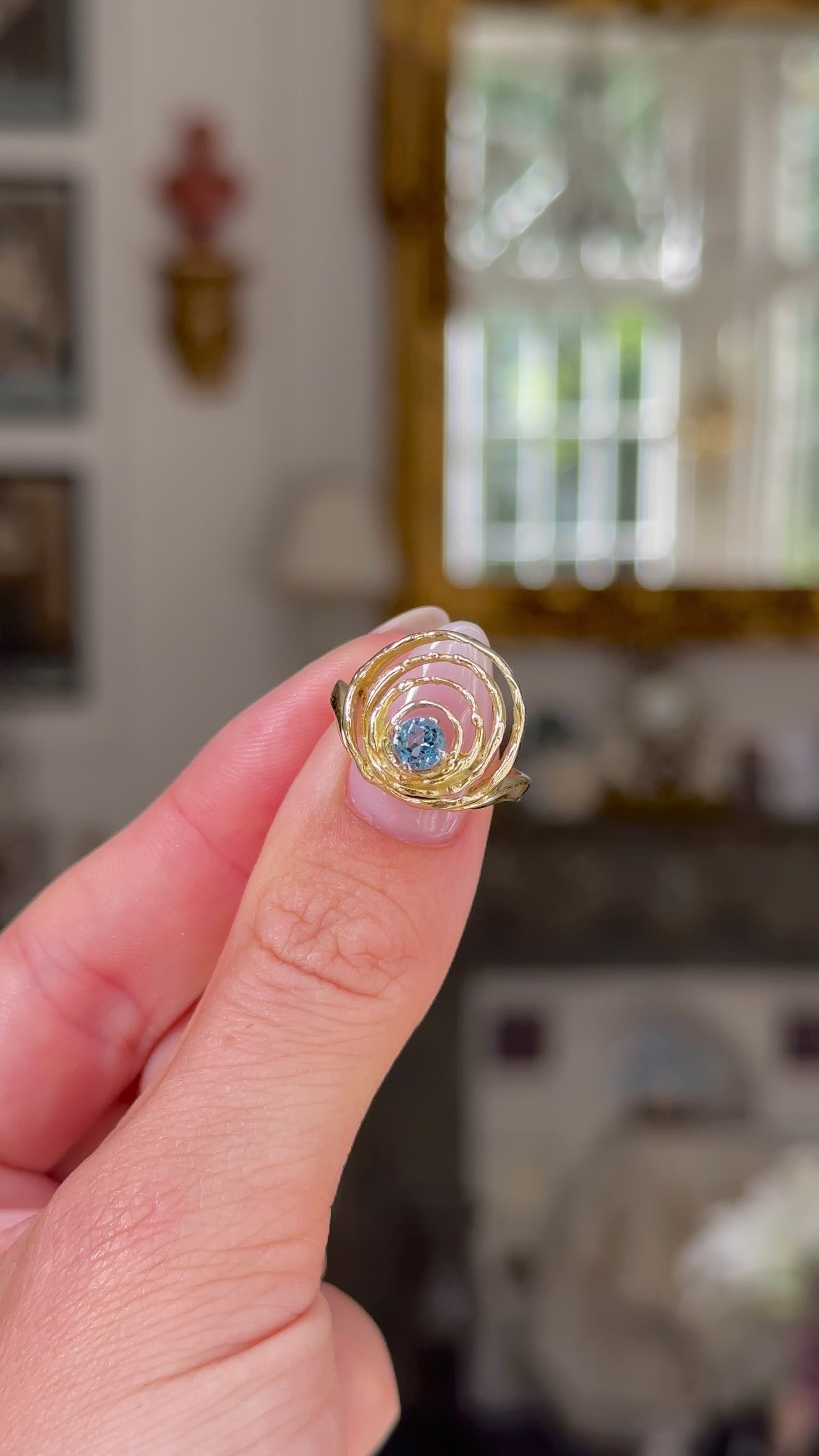 John donaldson sculptural aquamarine ring held in fingers and moved around to give perspective.