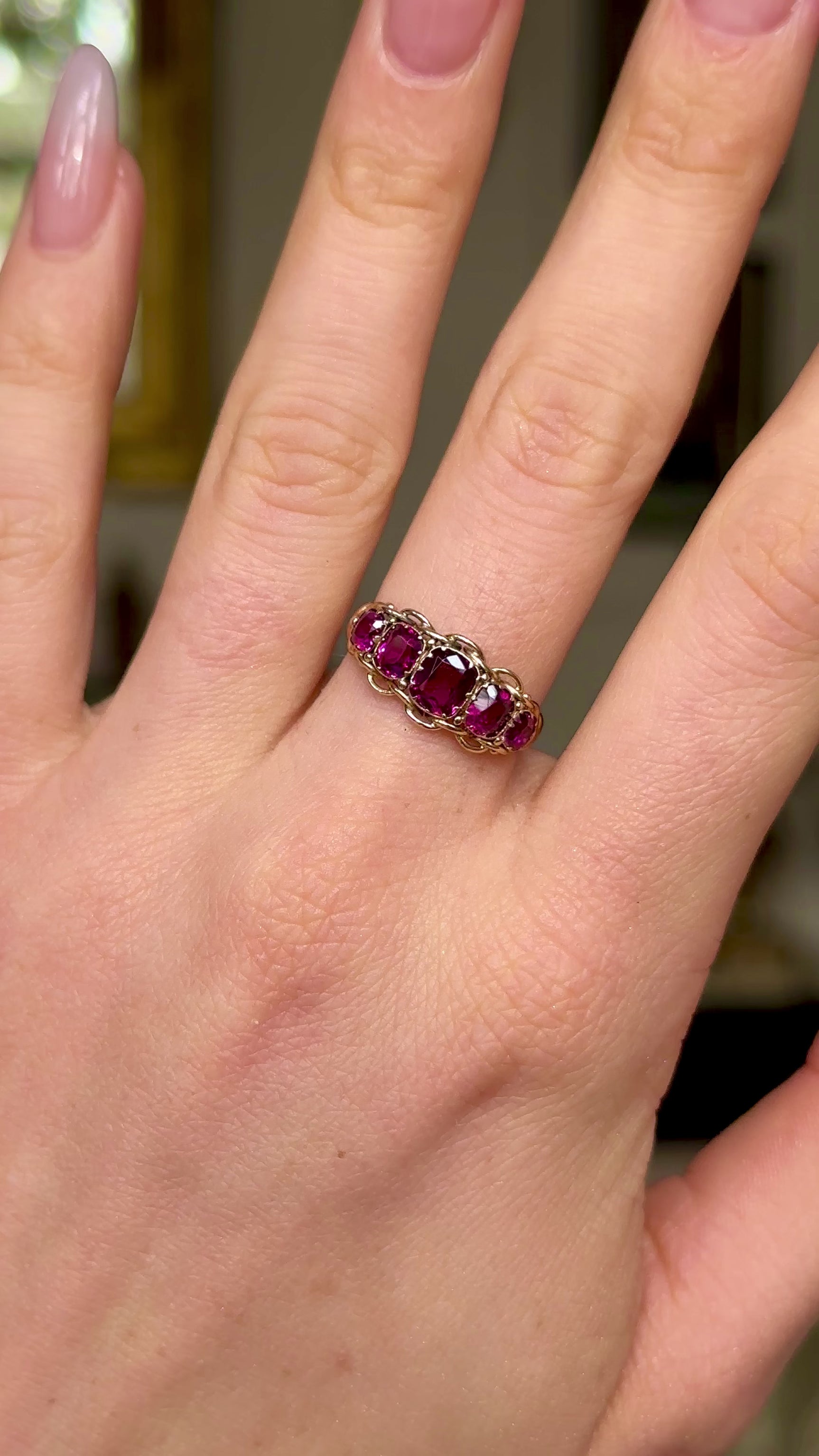 Victorian five-stone garnet and yellow gold ring, worn on hand and moved around to give perspective.