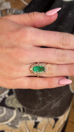 Video of an Antique Belle Epoque emerald and diamond cluster ring in yellow gold worn on the hand as its turned to show how3 it fits