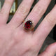 Belle Époque red garnet ring, worn on hand moved around to give perspective.