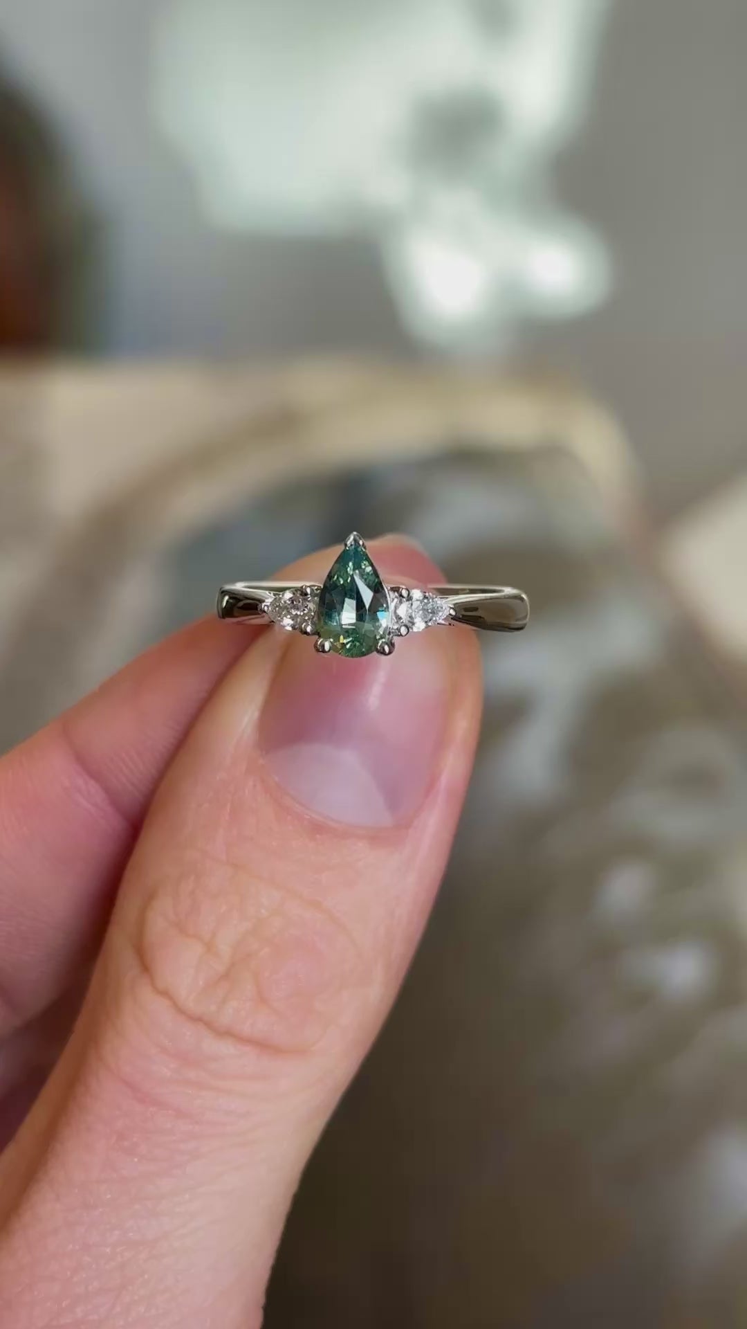 Pear-cut teal sapphire & diamond three-stone engagement ring