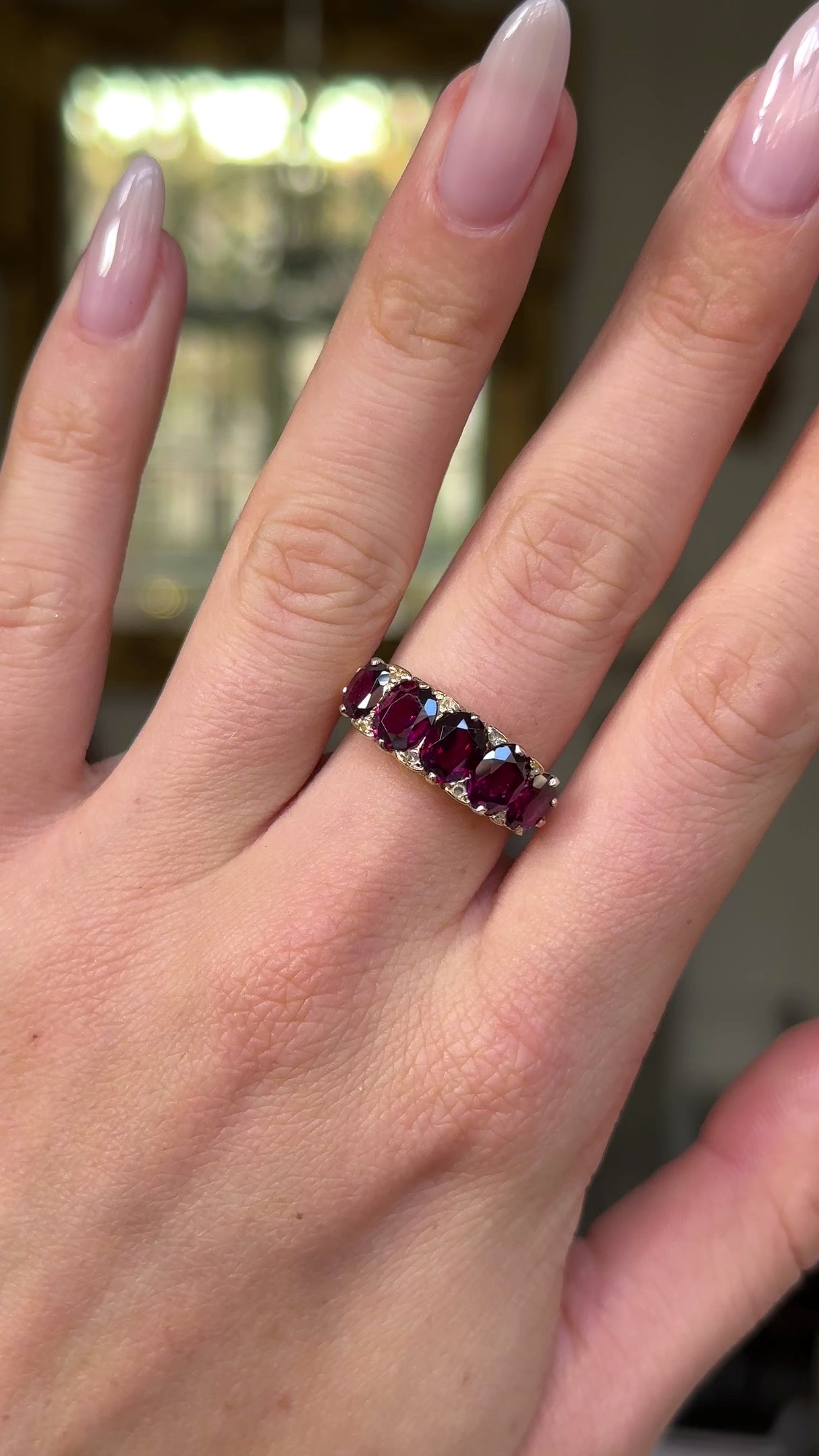 Victorian half hoop garnet ring worn on hand and moved around to give perspective.