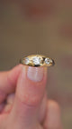Gold gypsy ring with three old cut diamonds showing smooth surface and subtle light reflections