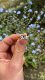 Antique, Edwardian Sapphire and Diamond Three-Stone Engagement Ring, 18ct Yellow Gold held in fingers.