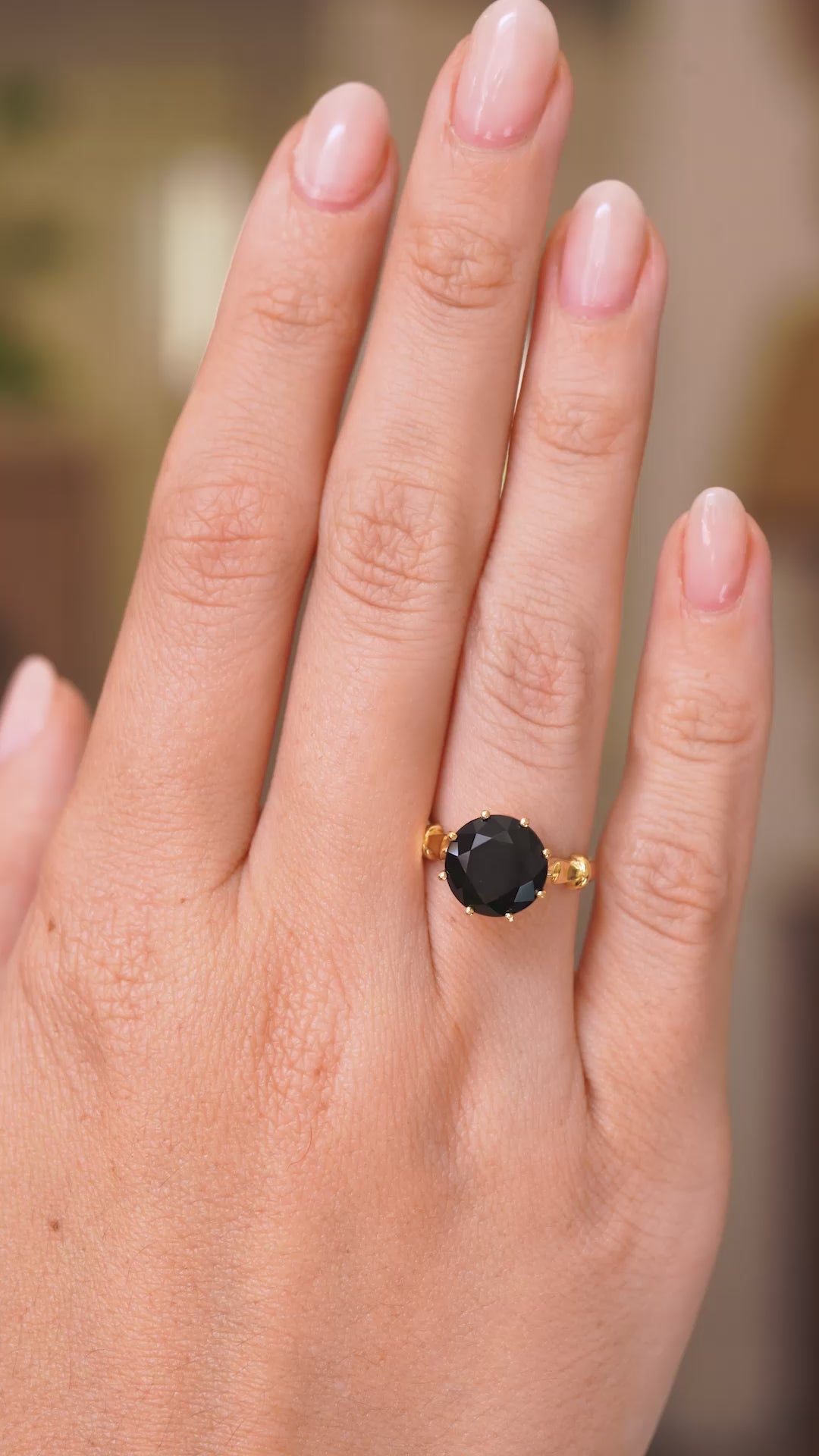  A video of a hand wearing a Vintage, 1980's green tourmaline cocktail ring, showcasing the profile of the ring  and yellow gold band once worn on a finger. 