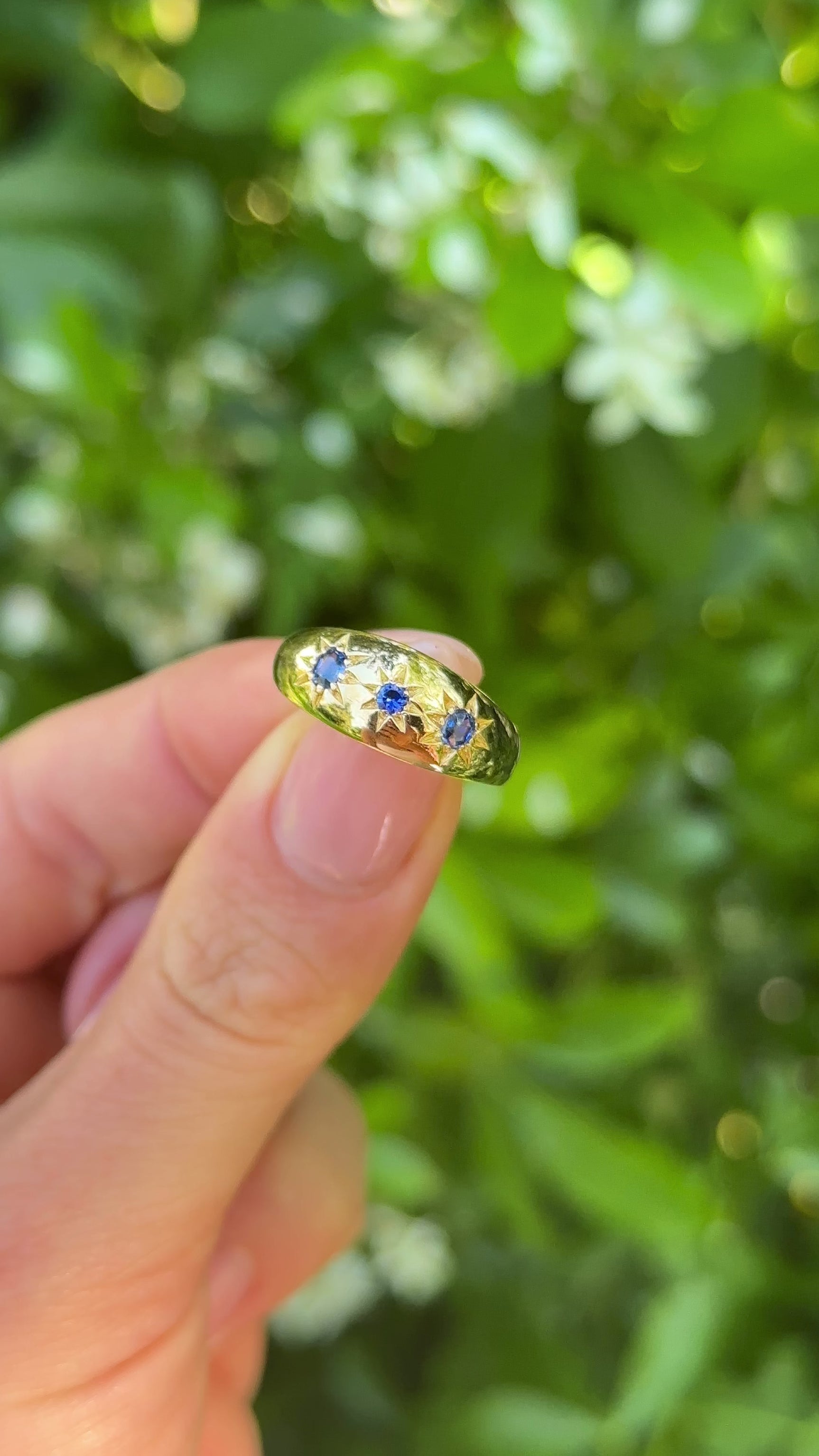 Antique, Victorian Three-Stone Sapphire Gypsy Ring, 18ct Yellow Gold held in fingers.