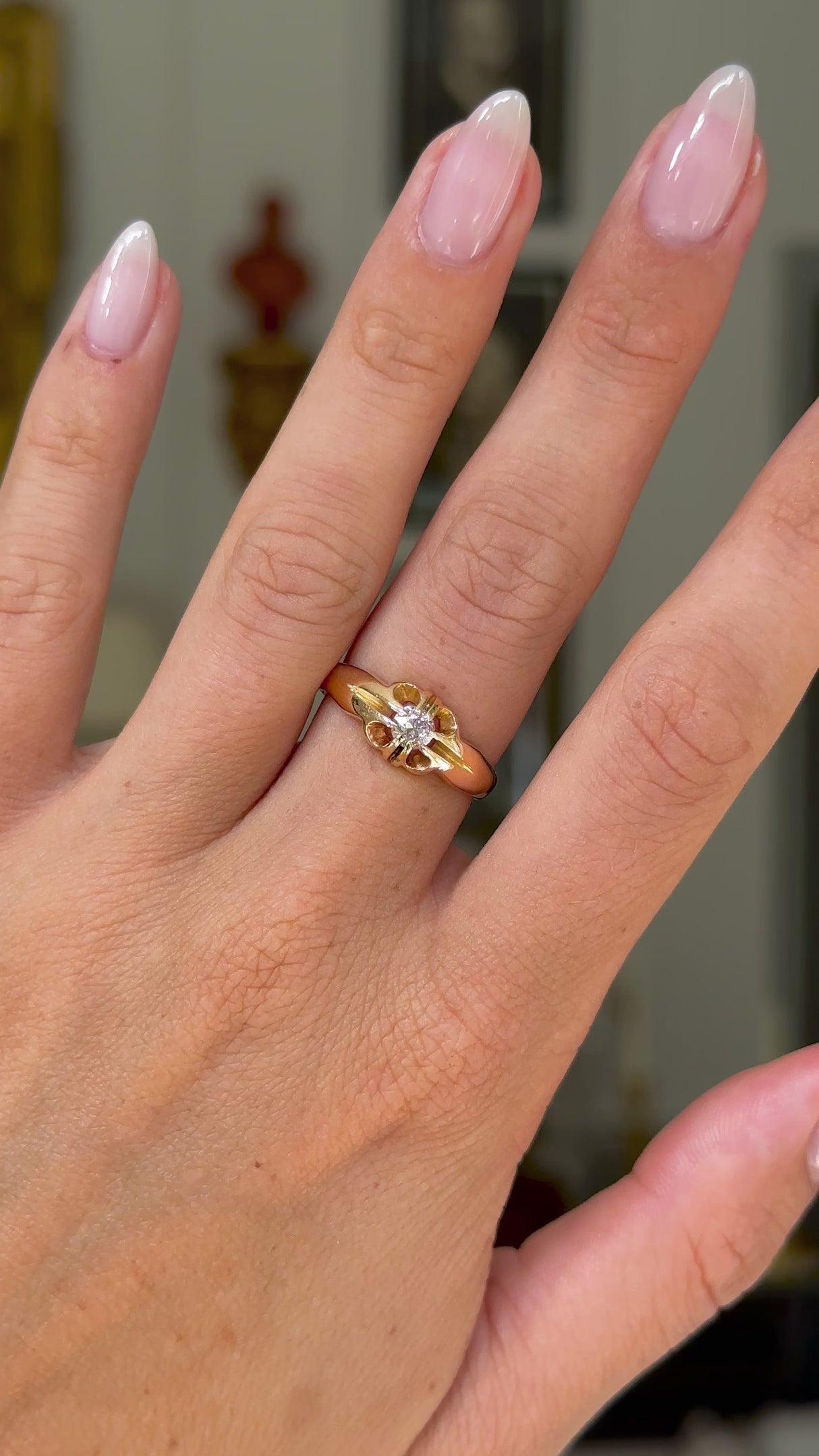 solitaire diamond engagement ring worn on hand and moved around to give perspective.