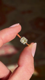 Vintage 1950s brown old-mine cut diamond solitaire engagement ring featuring a brown old-mine cut diamond in a timeless solitaire design, held by hand for detailed viewing.