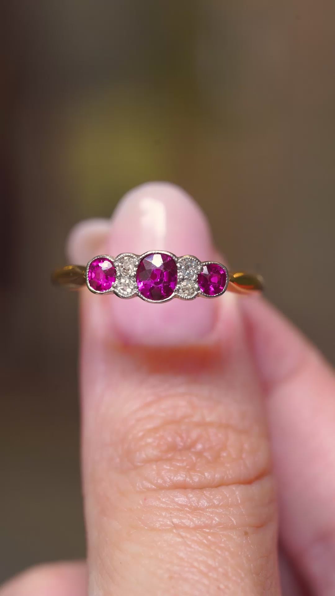 A close-up video of an antique Edwardian five-stone ring featuring natural rubies and old-cut diamonds.