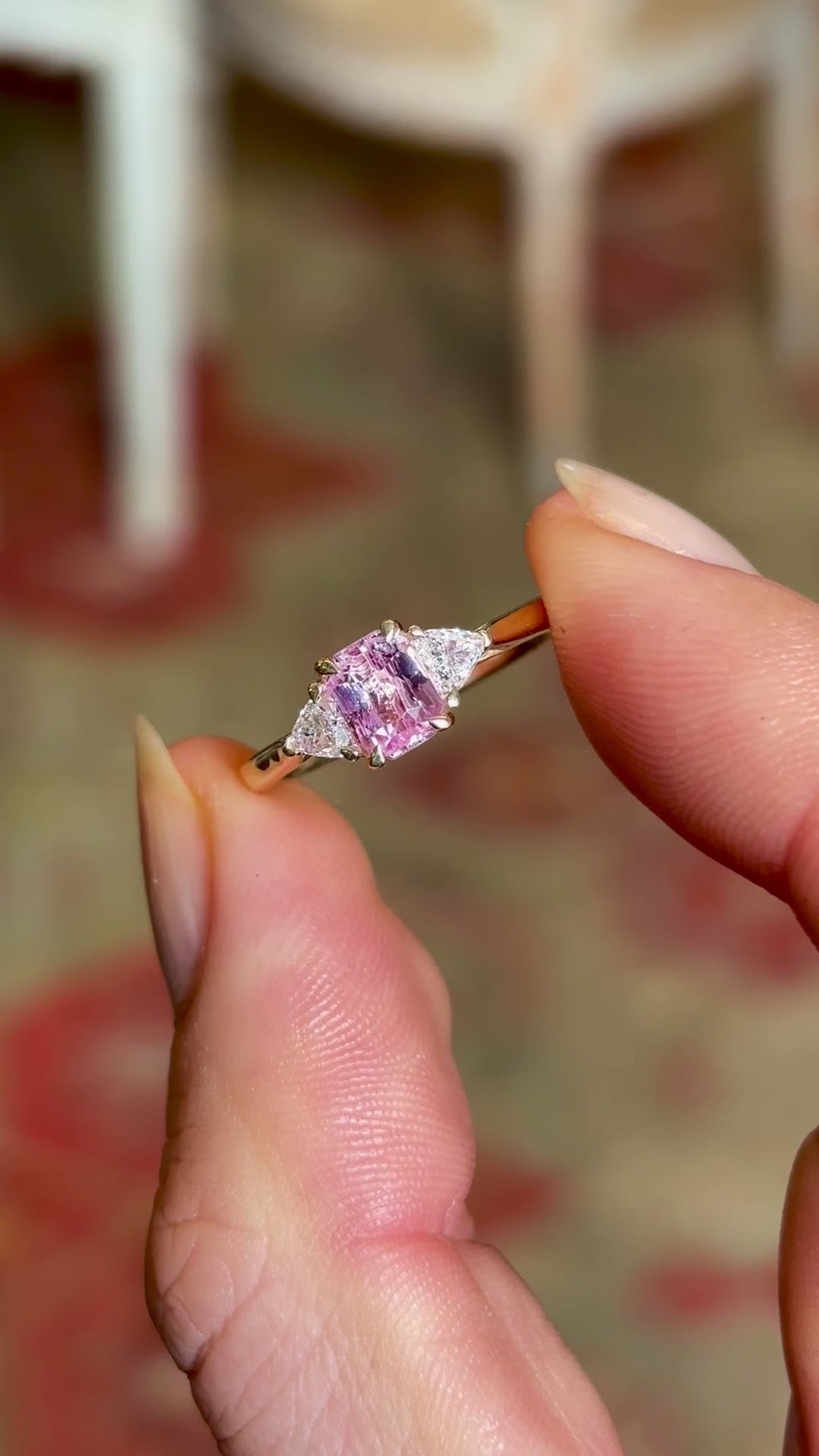 Pink sapphire and diamond three-stone engagement ring