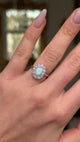 Edwardian opal and diamond cluster ring worn on hand and moved around to give perspective.