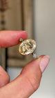 Closeup video of a yellow gold Vintage, 1980s large yellow sapphire & diamond three-stone engagement ring, showcasing the large central yellow sapphire