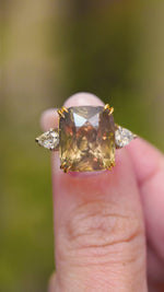 A video of a close-up of a large cushion-cut brown sapphire flanked by pear-shaped diamonds.