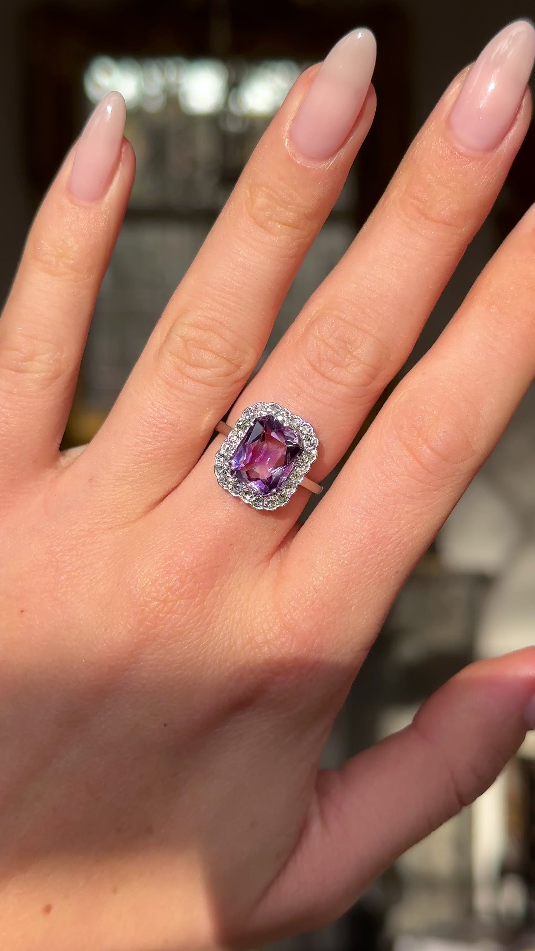 antique belle epoque amethyst and diamond cluster ring worn on hand and moved around to give perspective.