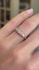 Antique Victorian old-mine diamond five-stone ring featuring five graduated old-mine cut diamonds, displayed on a hand.
