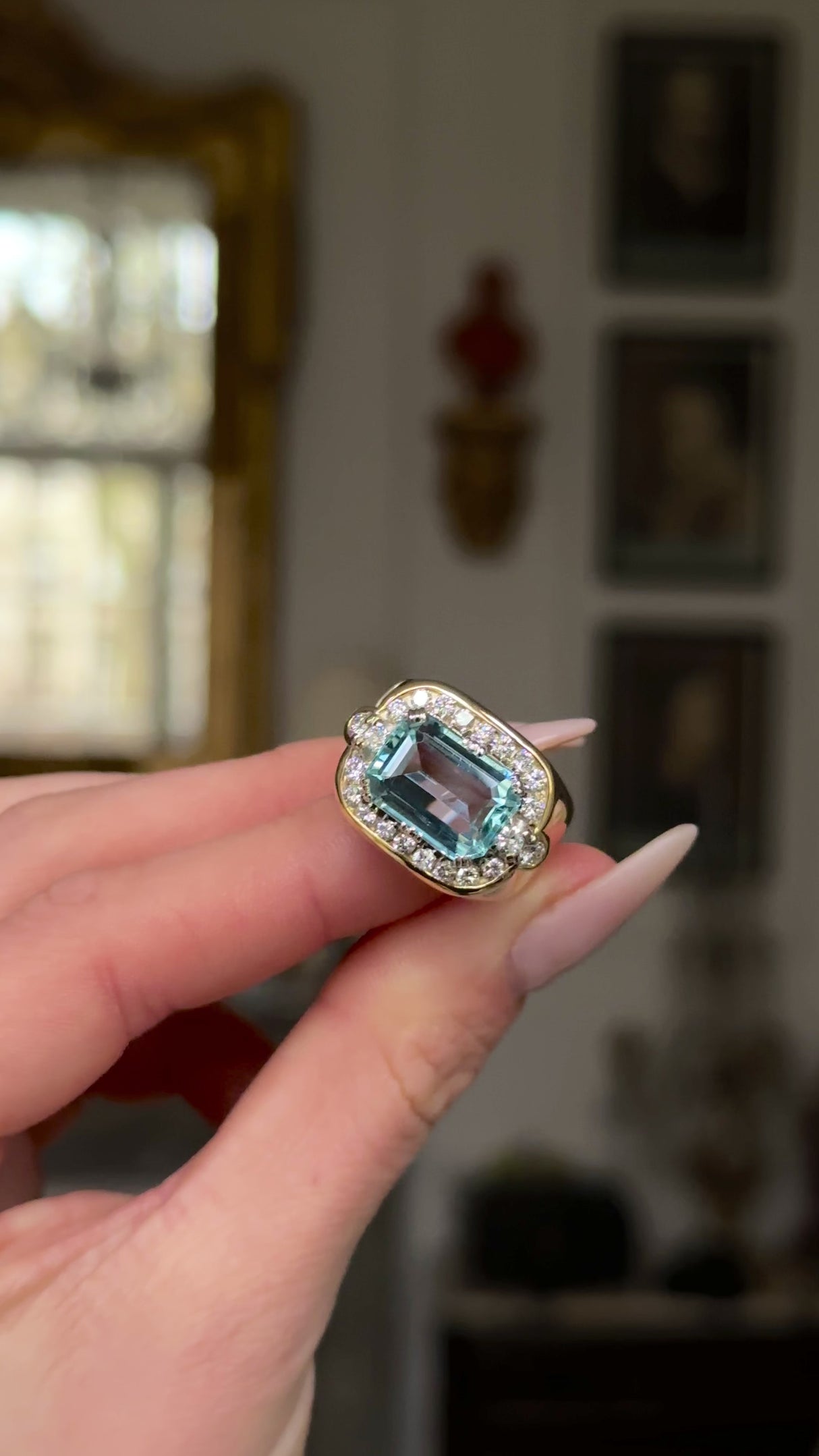 Aquamarine and diamond cocktail ring held in fingers and moved around to give perspective.