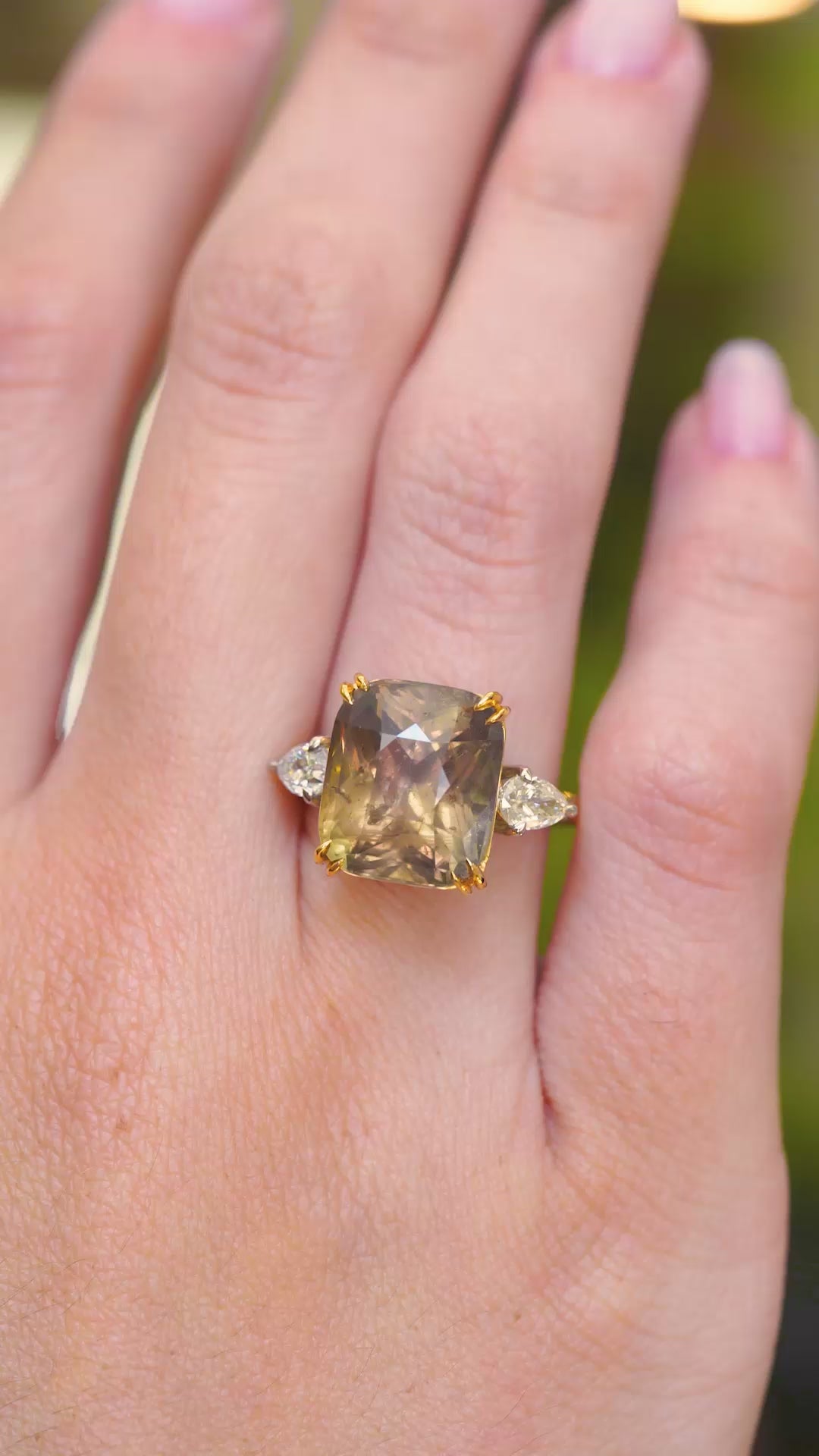 A video of a brown sapphire and diamond cocktail ring worn on the finger.