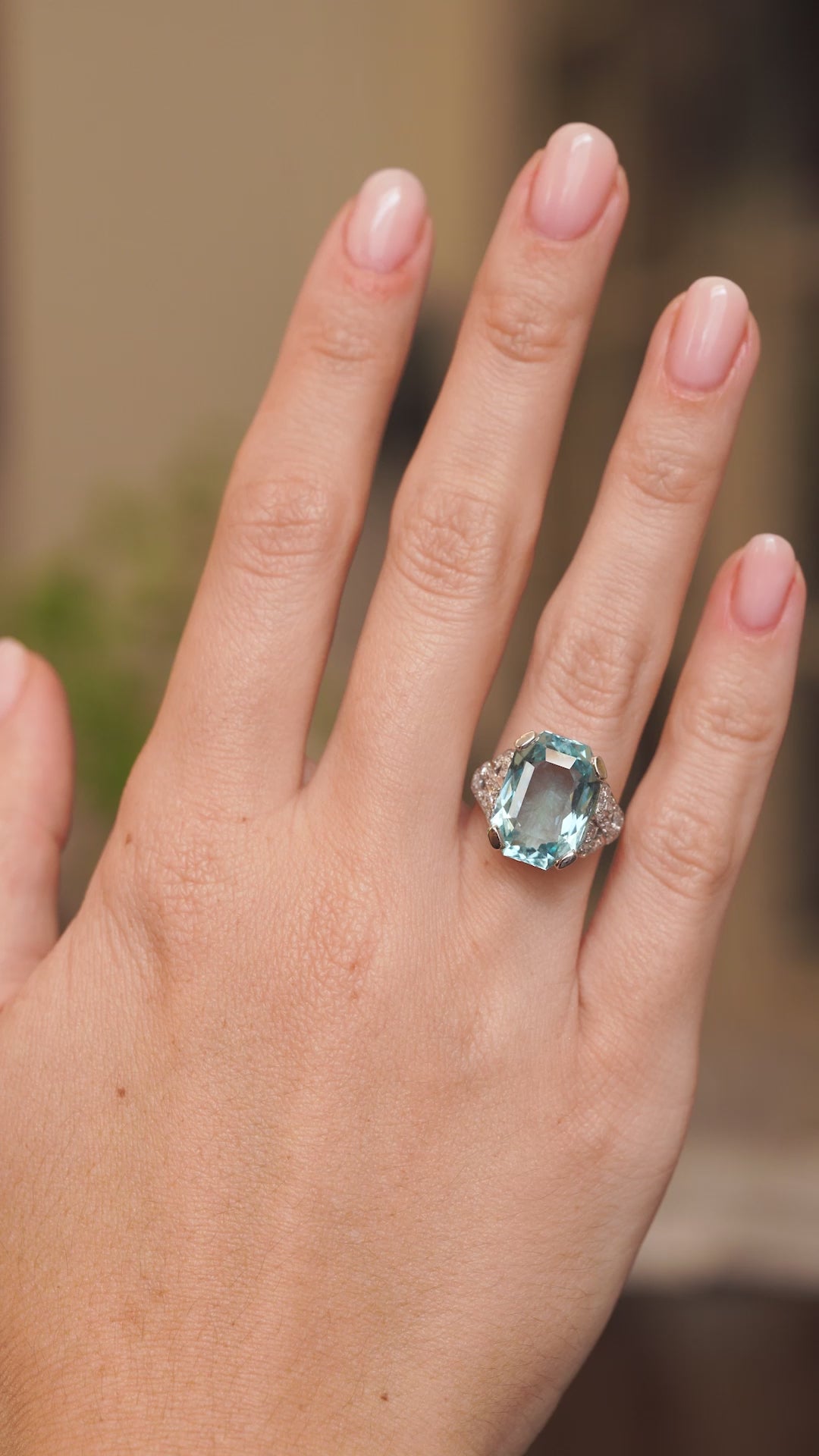 Video of an antique aquamarine and diamond cocktail ring worn on the hand, highlighting its icy blue colour and bold Art Deco proportions.